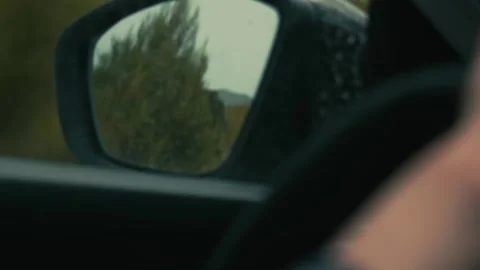 Trees and hills in the side mirror of a car Vídeos de archivo 229192673