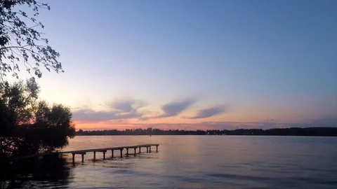 Trees and pier on the lake in sunset 스톡 동영상 82369600