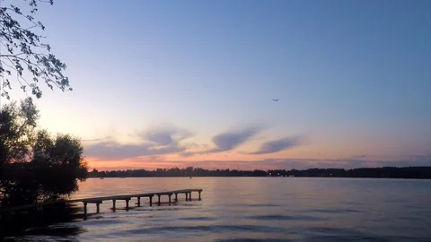 Trees and pier on the pond in sunset Stock Footage 82367590