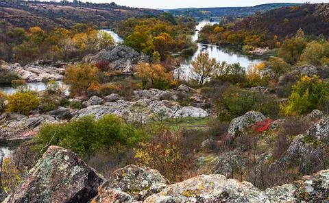 Trees and rocks on an island reflected in a Bug River in the Bugskiy gard par Stock Photos
