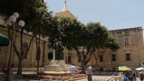 Trees and statue in square outside St. John's cathedral Stock Footage 84196243