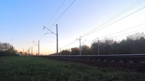 Trees and train on rails at sunset in spring timelapse Stock Footage 82986145