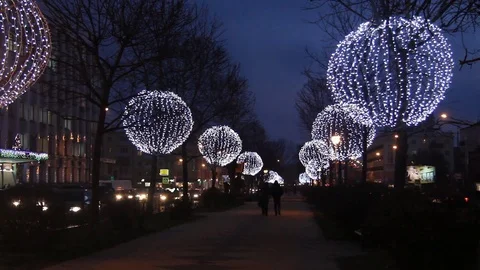 Trees decorated with glowing balls in the evening. Festive Christmas lighting. Stock Footage 82278357