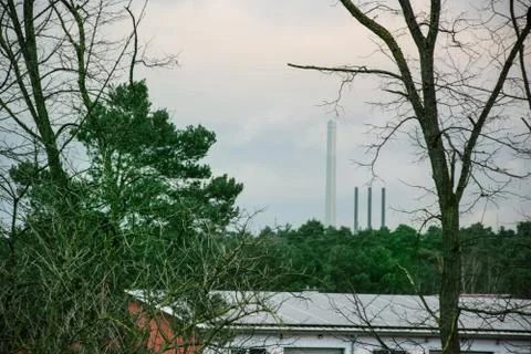 Trees with the factory building Stock Photos