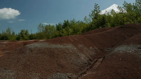Trees Grow above the Red Soil of the Badlands Stock Footage 92627628