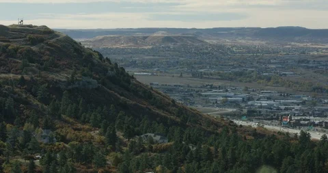 Trees on mountain slopes overlooking the road and settlement Stock Footage 96443218