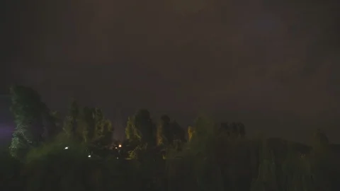 Trees moving fast in a dark night with storm and clouds, timelapse, 4k Stock Footage 97584901