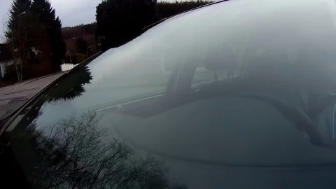 Trees reflected in car window. Windshield reflection. Car driving on a Country Stock Footage 73418867