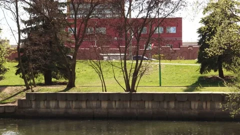 Trees, a river, a bike path with cyclists and a road with passing cars. Cyclists 스톡 동영상 131340578
