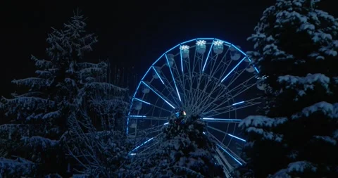 Trees with snow and a lighted wheel at the Christmas market Holiday background Stock Footage 314634435