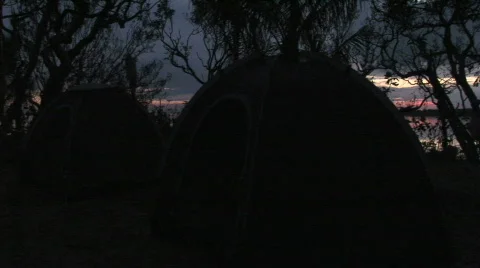 Trees tents ocean jib 5 Stock Footage