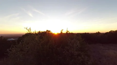 Treetop sun setting on the horizon Stockbeeldmateriaal 45674530