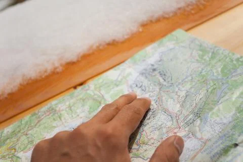 A trekker checking a map during his trip Stock Photos