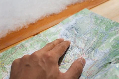 A trekker checking a map during his trip Stock Photos