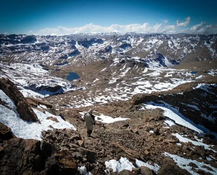 Trekker going down from the peak Stock Photos