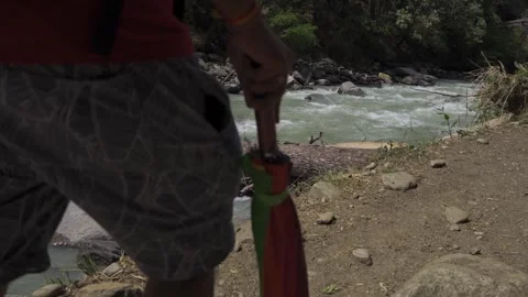 A trekker is passing by a river in a remote mountain region. Video stock 280263119