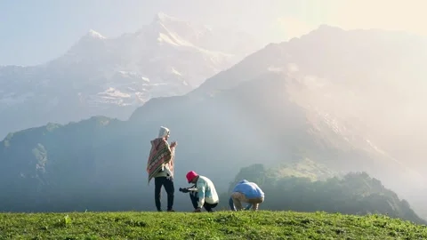 Trekkers admiring Himalayan mountain range Madmaheshwar, Uttarakhand, India Stock Footage 334706722