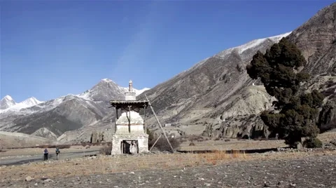 Trekkers pass old buddhist stupa Stock Footage 67646977
