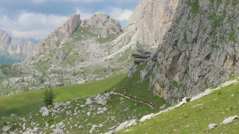 Trekkers walk in a row on a mountain path Stock Footage 177479915