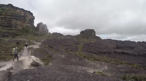Trekkers walking in the midst of clouds and mist Stock Footage 58647109