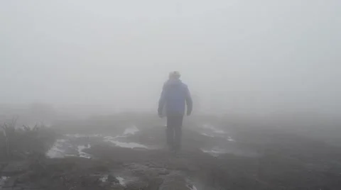 Trekkers walking in the midst of clouds Stock Footage 58630776