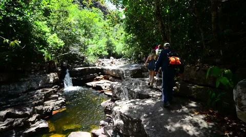 Trekkers walking on a riverside Stock Footage 58630846