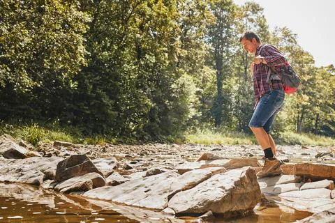 Trekking with backpack concept image. Backpacker wearing trekking boots cro.. Stock Photos
