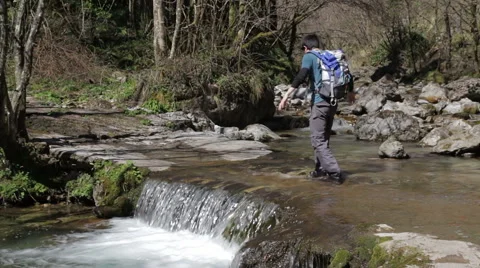 Trekking - boy crosses the river - a river ford Stock Footage 49132780