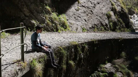 Trekking - break to eat something, on the edge of the paved path Stock Footage 49046331