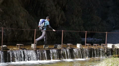 Trekking - crossing the river on a row of rocks quickly Stock Footage 49059799
