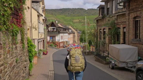 Trekking hiker walking through a small Rhine Valley town  Stock-Footage 303666868