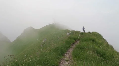 Trekking on the mountain top with low clouds Stock Footage 50946347