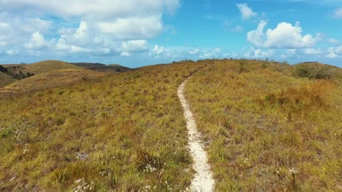 Trekking Path Way Teletubbies Hill. Drone Shot Tropical Savanna Hills at Nusa Stock Footage 113885254