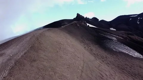 Trekking to the top of the black volcano Stock Footage 167856909