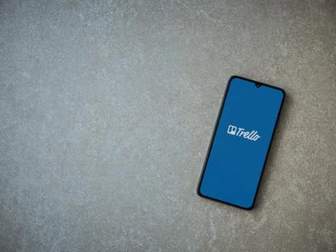 Trello app launch screen with logo on the display of a black mobile smartphon Stock Photos