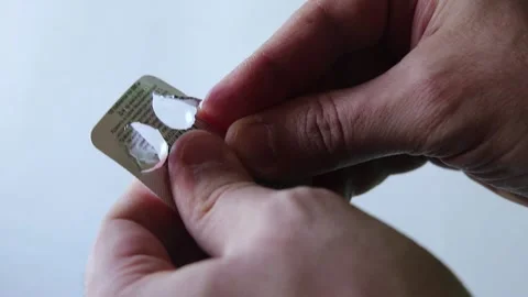 Trembling hands open the package with the pills Stock Footage 149219625