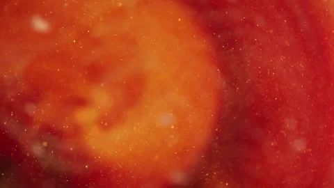 Trembling liquid with dissolved particles of red orange candurin and bubbles slo Видео 306073841