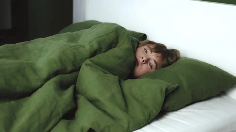 Trembling little boy sleeping lying in a bed feeling bad. Sick ill boy teenager Stock Footage 264316958