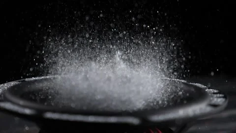 Trembling loudspeaker throwing silver flour in the air. Super slow motion close Stock Footage 141157387