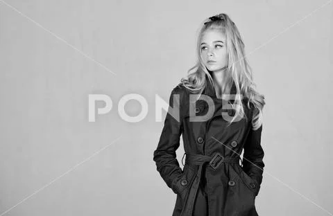 Trench coat fashion trend. Must have concept. Fashionable coat. Woman makeup Stock Photos