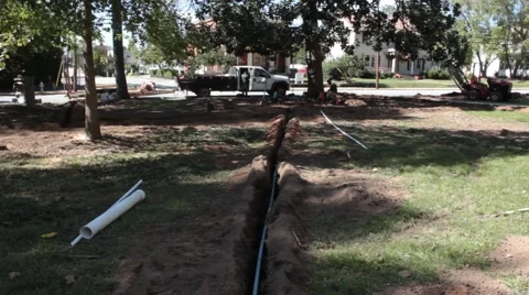 Trenched Line in Ground Leads to Plumbers and Their  Vehicle Stock Footage 46890868