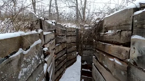 Trenches in the snow in winter. Move the camera forward. A real war. Military Stock Footage 266820146