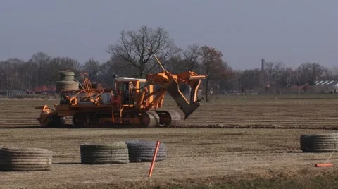 Trenchless drainage machine moving lateral across the field Stock Footage 61381090
