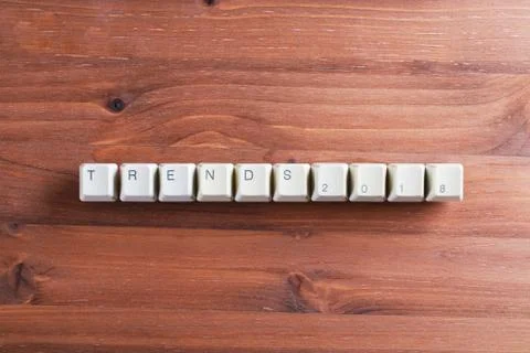 Trends 2018 concept on computer keyboard keys on a wooden background Foto stock