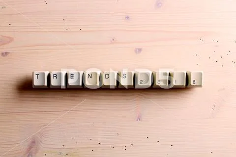 Trends 2018 concept on computer keyboard keys buttons on a wooden background Stock Photos