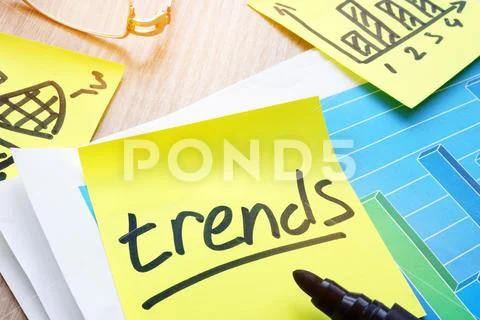Trends handwritten on the memo stick. Stock Photos