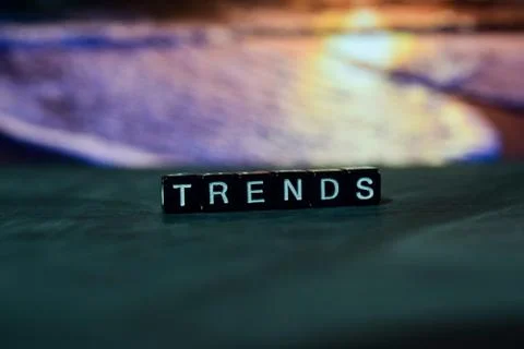 Trends on wooden blocks. Cross processed image with bokeh background Stock Photos