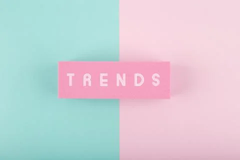 Trends written on rectangle on light multicolored in the middle of pink and aqua Stock Photos