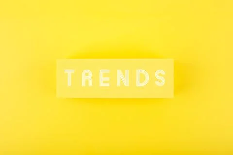 Trends written on rectangle in the middle of bright yellow background Stock Photos