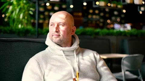 Trendy attractive man drinking coffee in cafe. Handsome man drinks coffee in Stock Footage 149000345